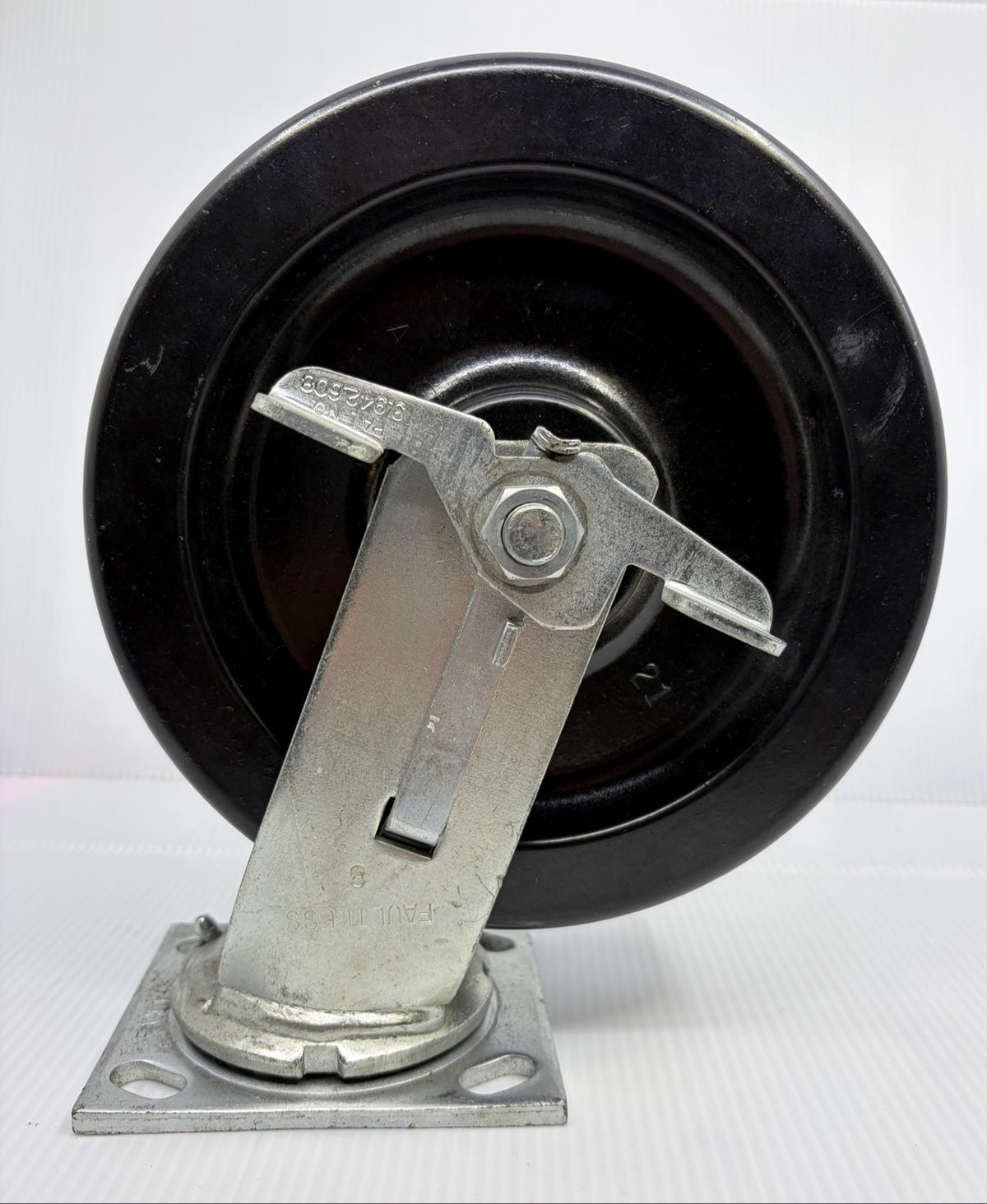 Faultless 8 inch phenolic swivel caster with face contact brake, brake pedal and FAULTLESS 8 fork stamp side view
