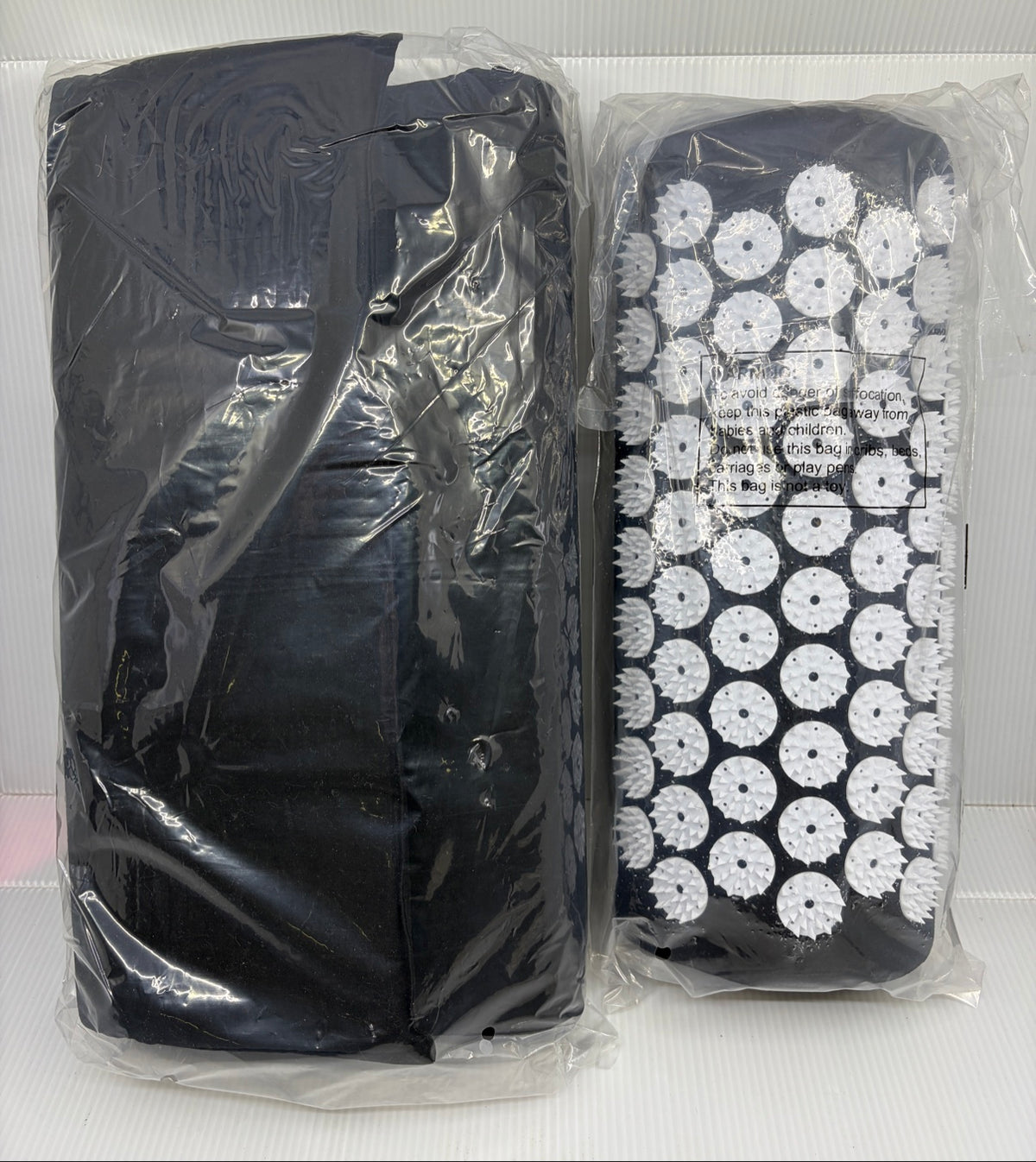ProsourceFit acupressure mat and pillow set in black, sealed in plastic bags, full set front view