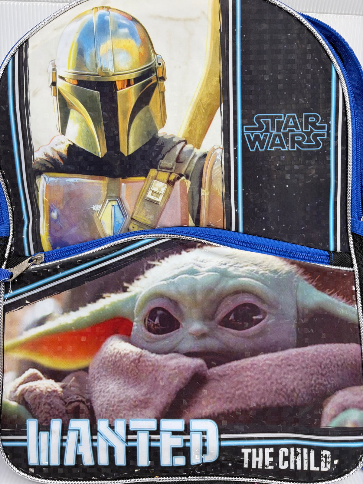 Close-up front view of the Mandalorian backpack showing Mandalorian armor art, Star Wars logo and Grogu face on the front pocket