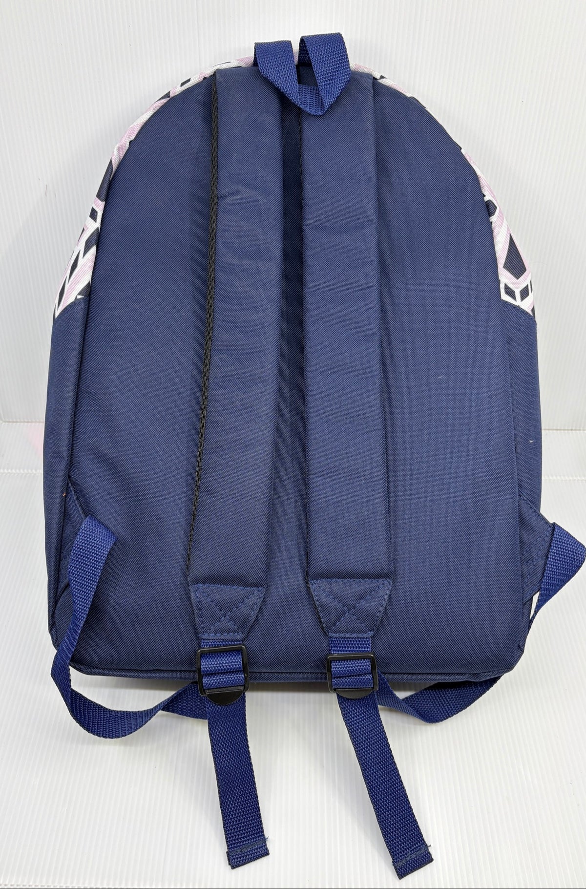 Back view of the Ivory Ella Conair backpack showing navy padded adjustable shoulder straps and top grab loop
