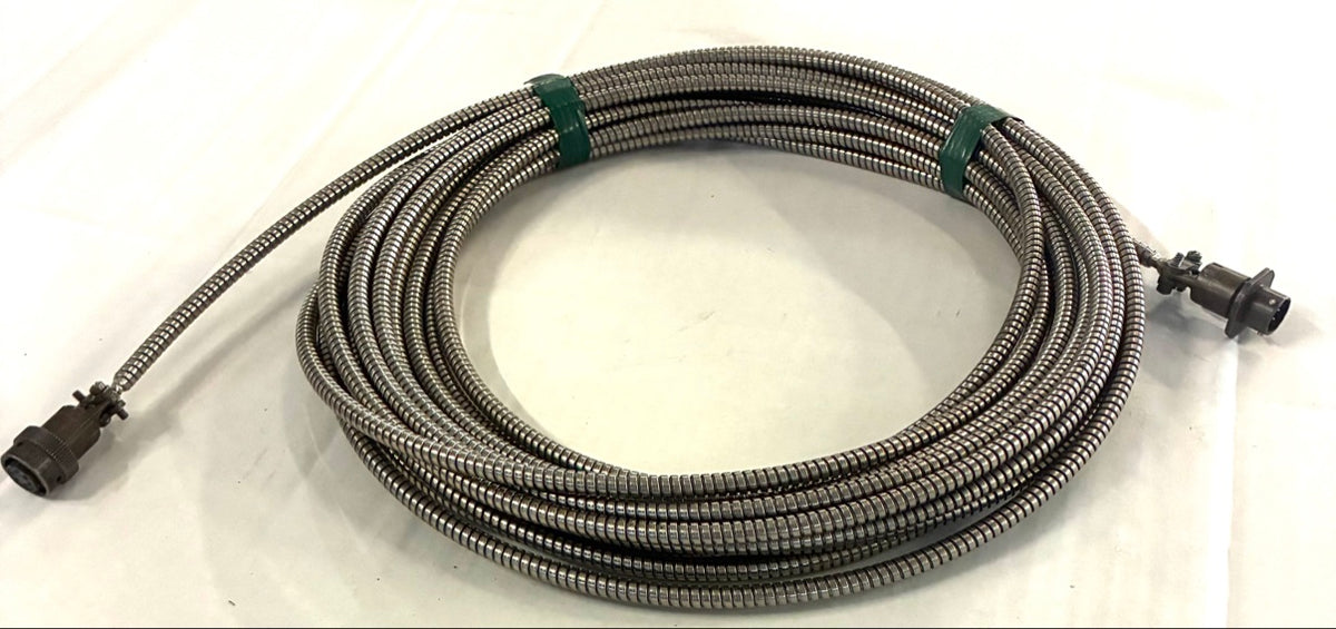 Coiled armored extension cable, full view showing both circular connectors and green tape ties