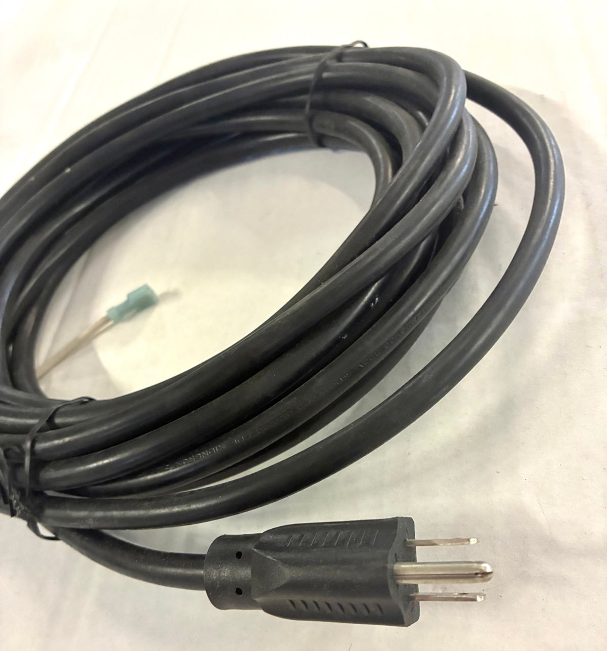 Close-up of molded NEMA 5-15P 3-prong grounded plug on 14 AWG cord