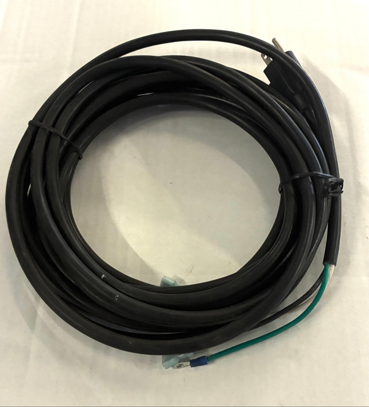 Power cord coil top view showing green ground lead with ring terminal