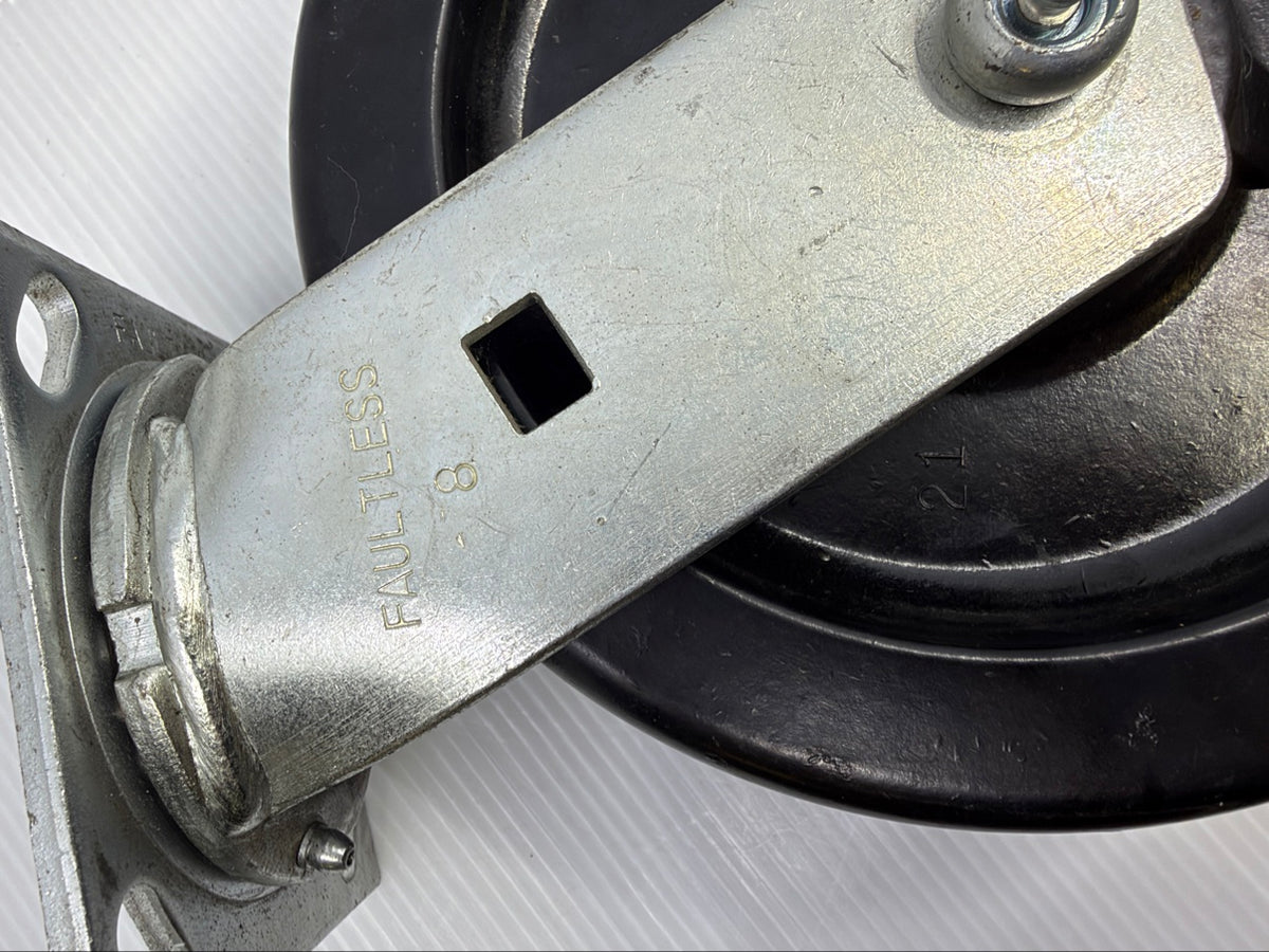 Close-up of FAULTLESS 8 stamp on caster fork leg and phenolic wheel