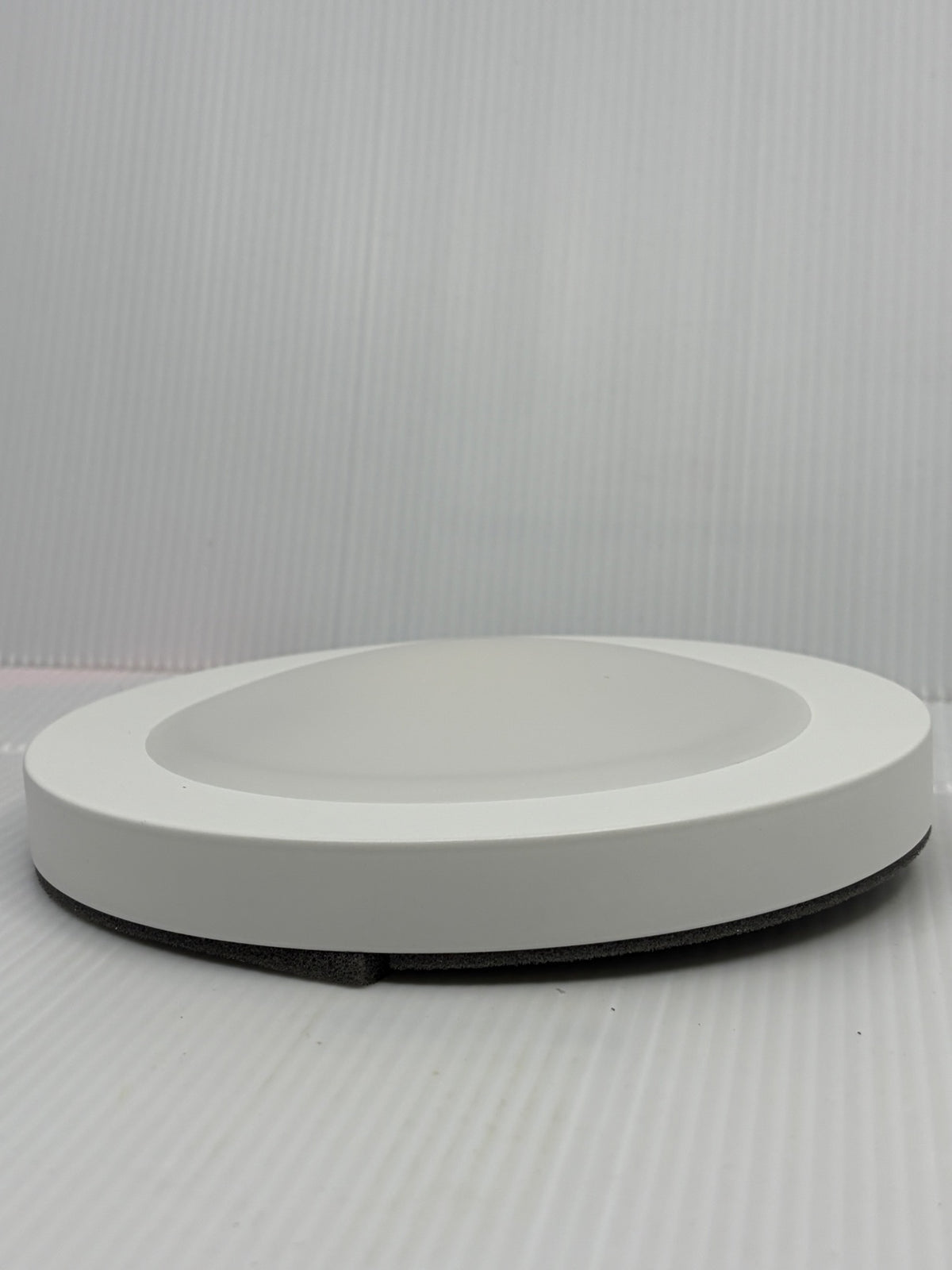 Side profile of Urban 33 7.5 inch LED disk light showing slim 1 inch low-profile flush mount design in white