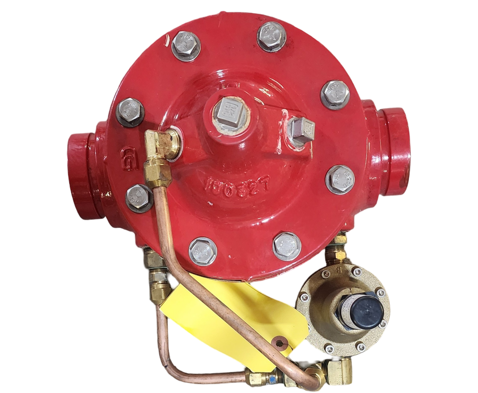 Red valve with brass components and a yellow inspection tag on a white background