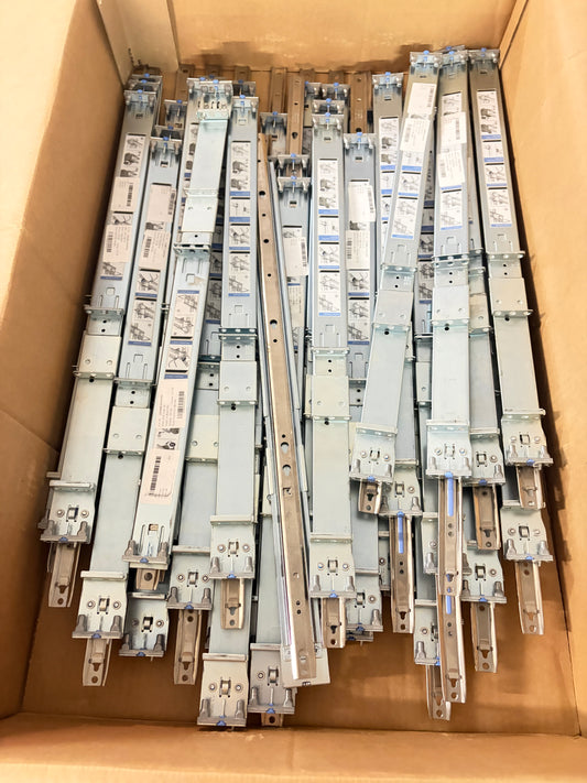Multiple metal rail kits stacked inside a cardboard box