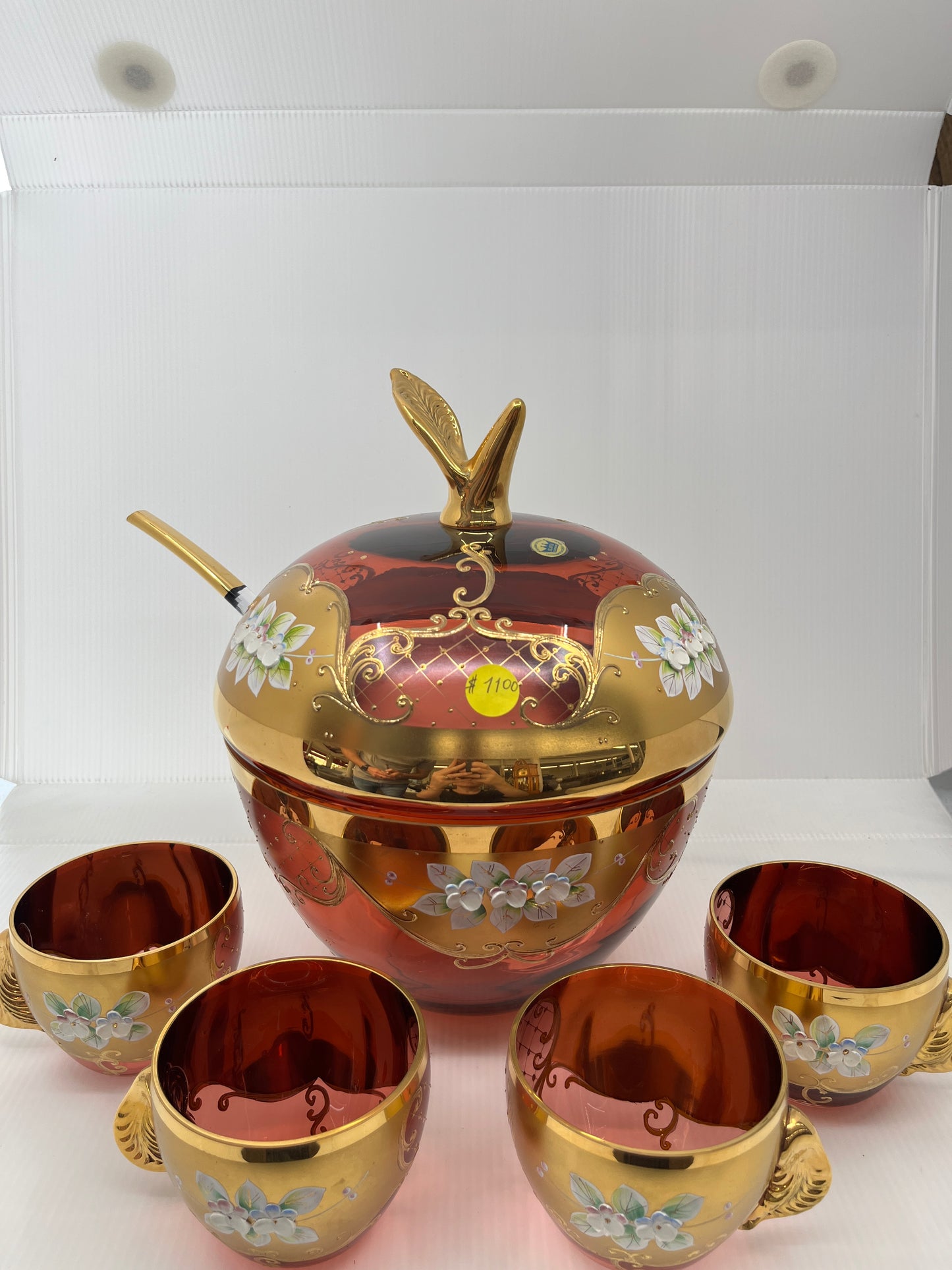 Decorative punch bowl set with floral designs on a white background.
